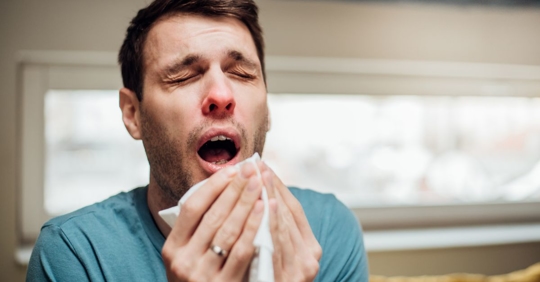man sneezing